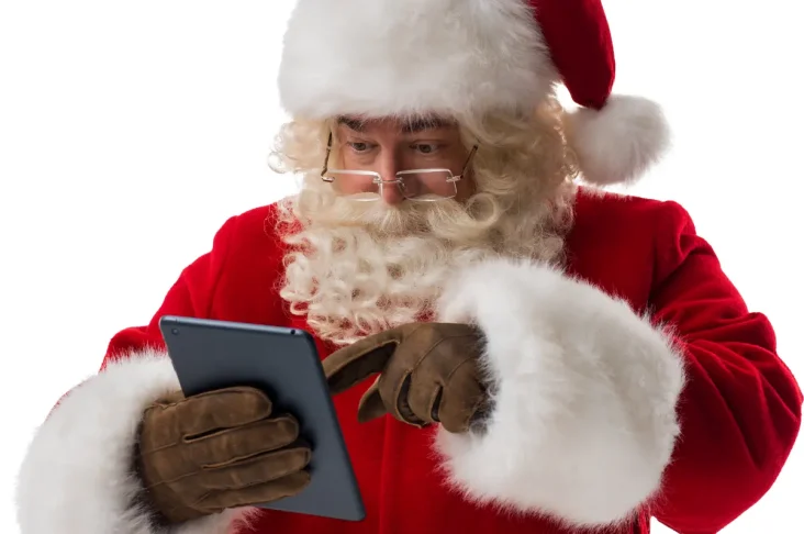 Santa reading a tablet